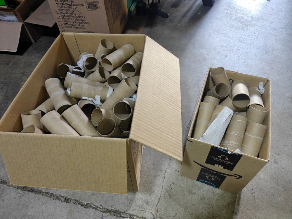 Two cardboard boxes full of cardboard tubes